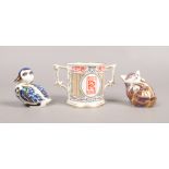 Two Royal Crown Derby paperweights, one with silver stopper, along with a Rolls Royce cup by Royal