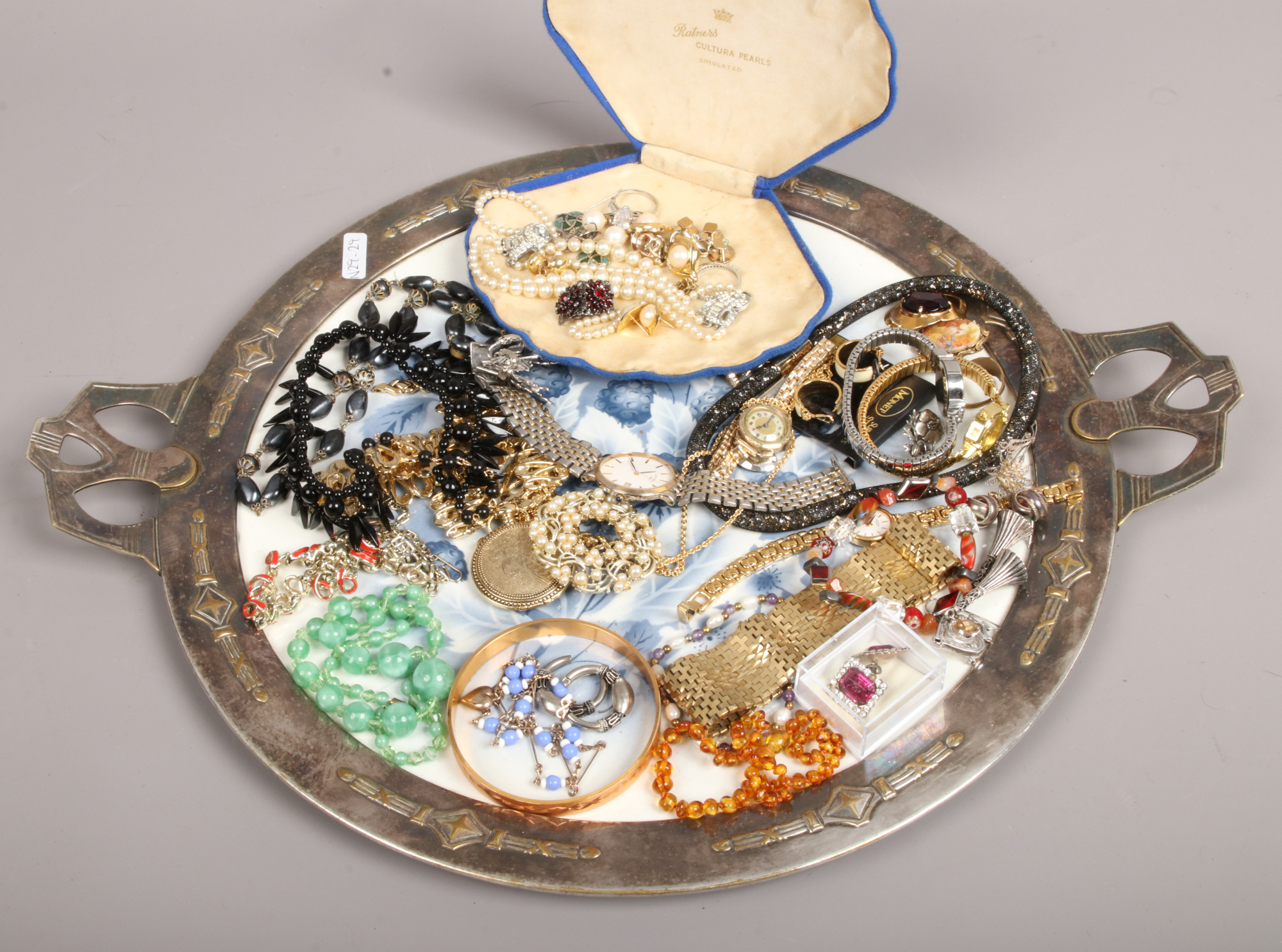 An Arts and crafts silver plated serving tray and assorted costume jewellery including simulated