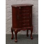 A modern jewellery cabinet / chest on cabriole supports, height approximately 72cm.Condition