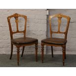 A pair of Victorian inlaid walnut salon chairs.