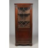 A George III mahogany standing corner cupboard with astrigal glazed top, 187cm high, 81cm wide.