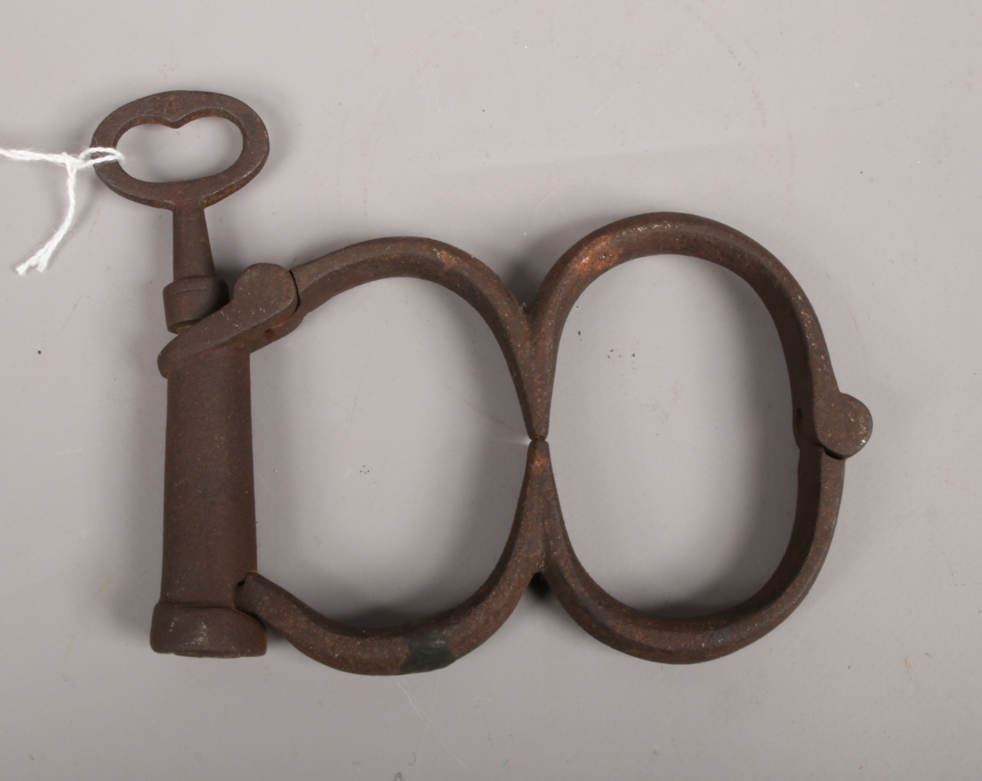 A set of steel 19th century Hiatt handcuffs with keyCondition report intended as a guide only.Cut