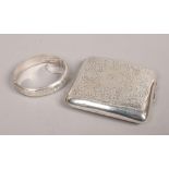 An engraved silver cigarette case assayed Birmingham 1946 and a silver bangle.