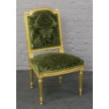 A French gilt chair with green floral upholstery and reeded tapering supports.