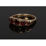 A 9ct gold and garnet five stone set ring, size M1/2.