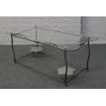 A decorative glass top coffee table with metal frame.