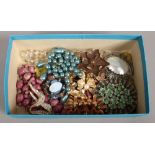 A box of 1950s costume jewellery including brooches and beads etc.