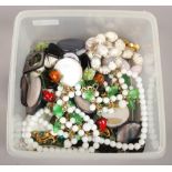 A box of vintage costume jewellery including a novelty glass fruit necklace, brooches etc.