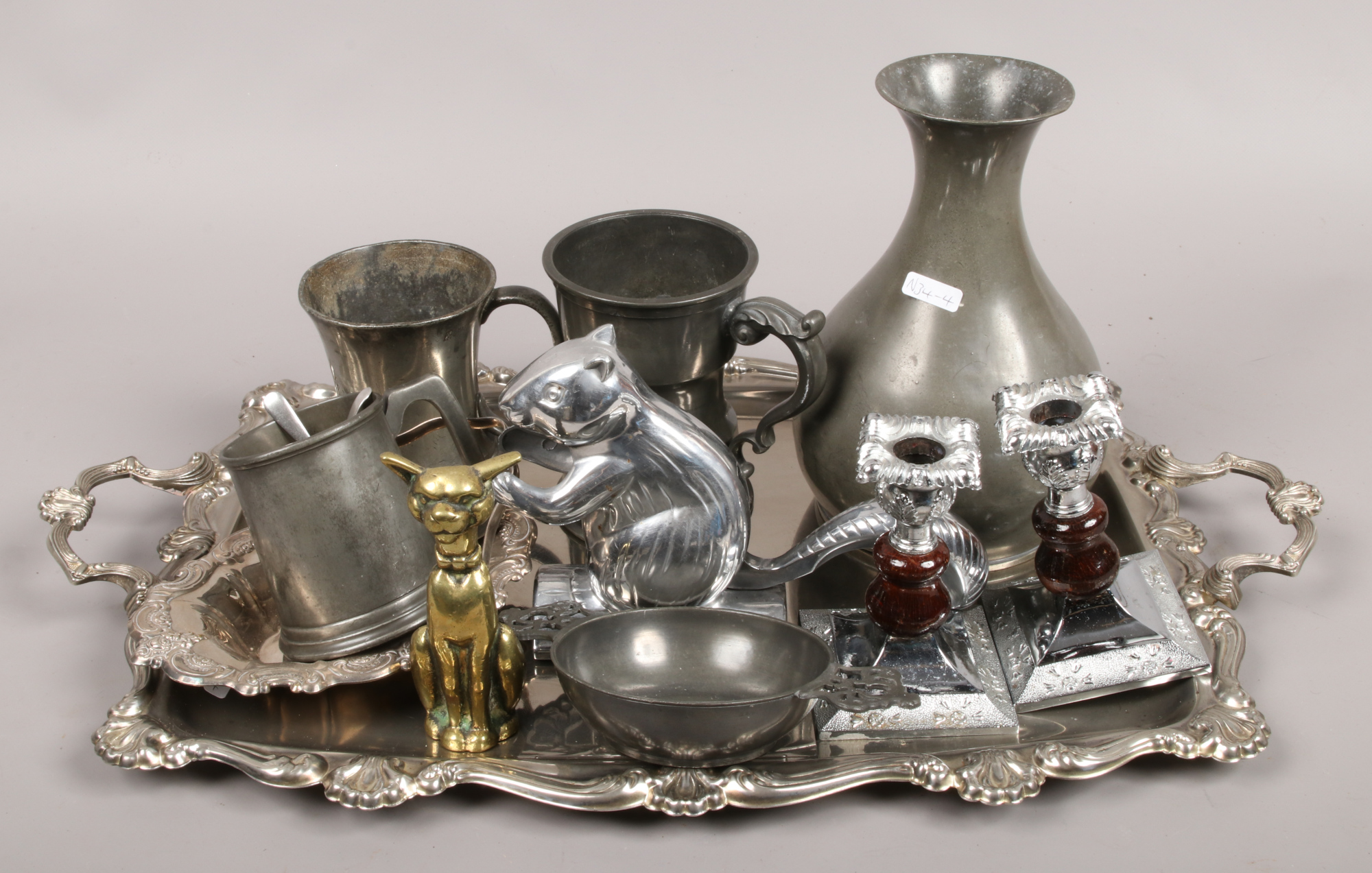 A quantity of silver plate and pewter including tankards, candlesticks and a serving tray etc.