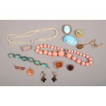 A tin of assorted agate and paste costume jewellery including rose quartz brooch, banded agate