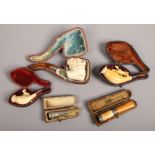Three cased meerschaum smoking pipes, along with two cased silver decorated cheroot holders, some