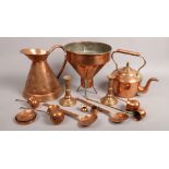 A collection of copperwares; large kettle jug and funnel, along with candlesticks, ladles etc.
