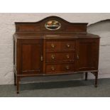 A carved mahogany breakfront sideboard with mirror back.