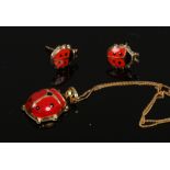 An enamelled 9ct gold ladybird pendant on chain and pair of matching ear studs.