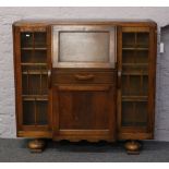 A carved oak side by side bureau bookcase.