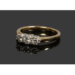 An 18ct gold three stone diamond ring, principle stone approximately 0.1ct size K.