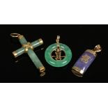 A gold mounted jade crucifix pendant and two 9ct gold mounted Chinese jade pendants ornamented