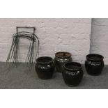 Four glazed terracotta planters along with a quantity of plant supports.