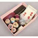 A box of vintage sewing items including Sylko cotton reels, buttons, Bakelite needle box etc.