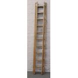 A set of wooden 3 tier extending ladders.