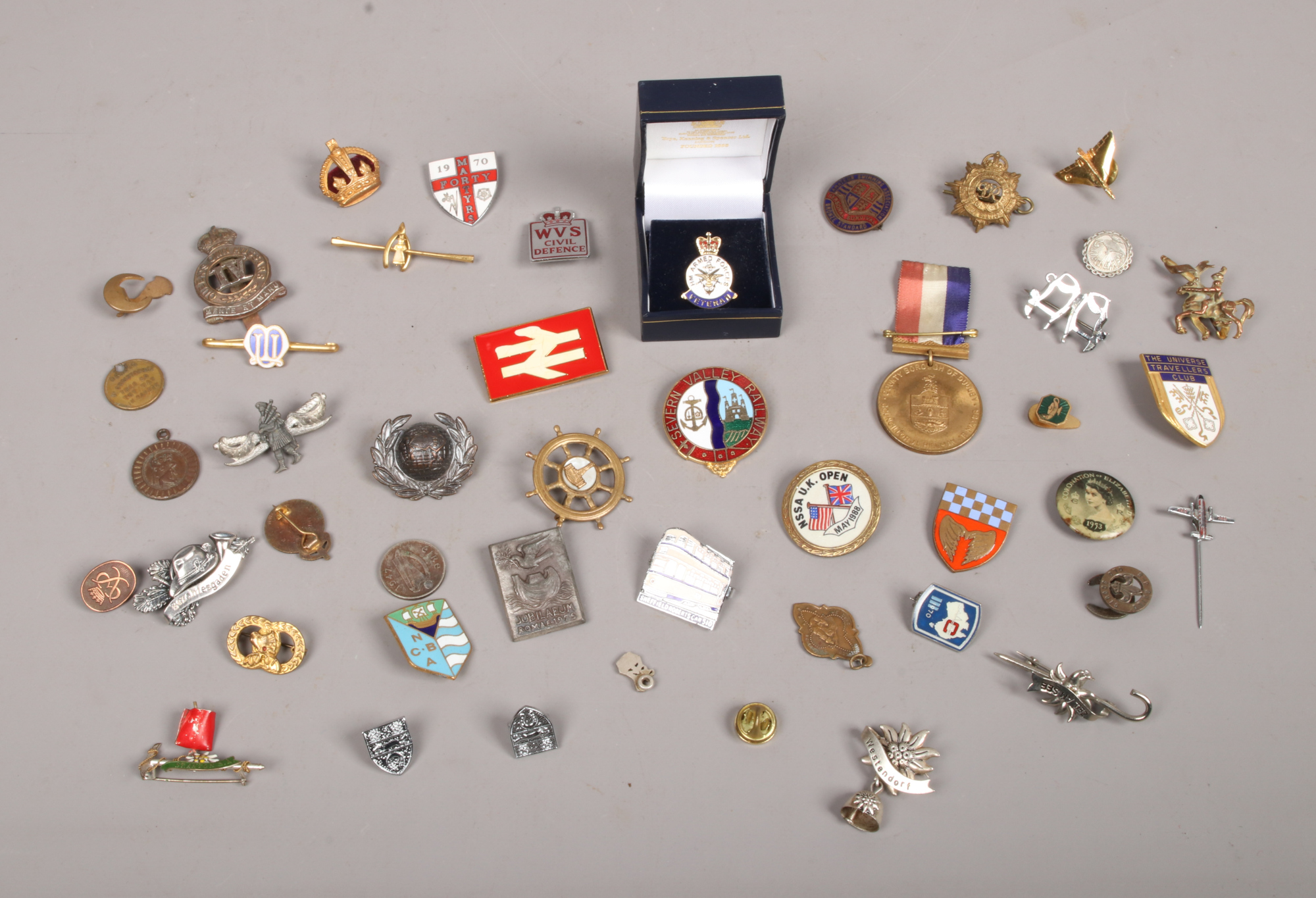 A collection of badges and brooches to include Armed Forces, Civil Defence, Royal Army Service Corps