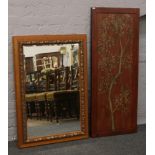 A decorative hardwood panel, along with an ornate framed bevel edge wall mirror.