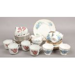 A Queen Anne bone china six place tea service along with a German made service decortaed with