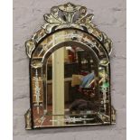 A decorative Venetian style wall mirror.
