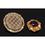 A Victorian Pinchbeck brooch along with a Victorian mourning brooch.