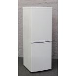 A tall standing fridge freezer.