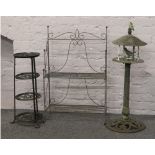 Two iron garden plant stands, along with a bird table.