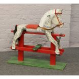 A painted wooden rocking horse, height 90cm, length 92cm.