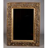 A large rectangular hall mirror in deep cushioned Florentine frame adorned with scrolling foliage