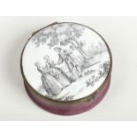 An 18th century English enamel table snuff box of circular form and with hinged cover. The cover