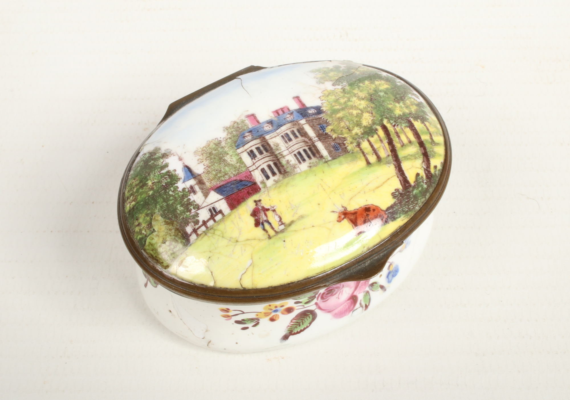 An 18th century Staffordshire enamel oval snuff box with hinged cover. Decorated to the top with a