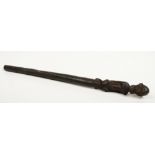 A West African hardwood staff terminal / topper. Surmounted with a stylized carved figure of a