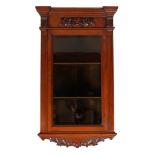 A Victorian mahogany glazed corner cupboard. With reeded supports, carved with holly leaves to the