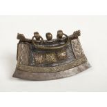 A 19th century Tibetan brass mounted leather tobacco pouch with curved flint striker along the base,