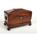 A mid Victorian rosewood tea caddy. With bobbin turned mouldings, brass loop handles and raised on