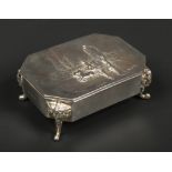 An Edwardian silver ring box of canted rectangular form by William Comyns & Sons. Embossed to the