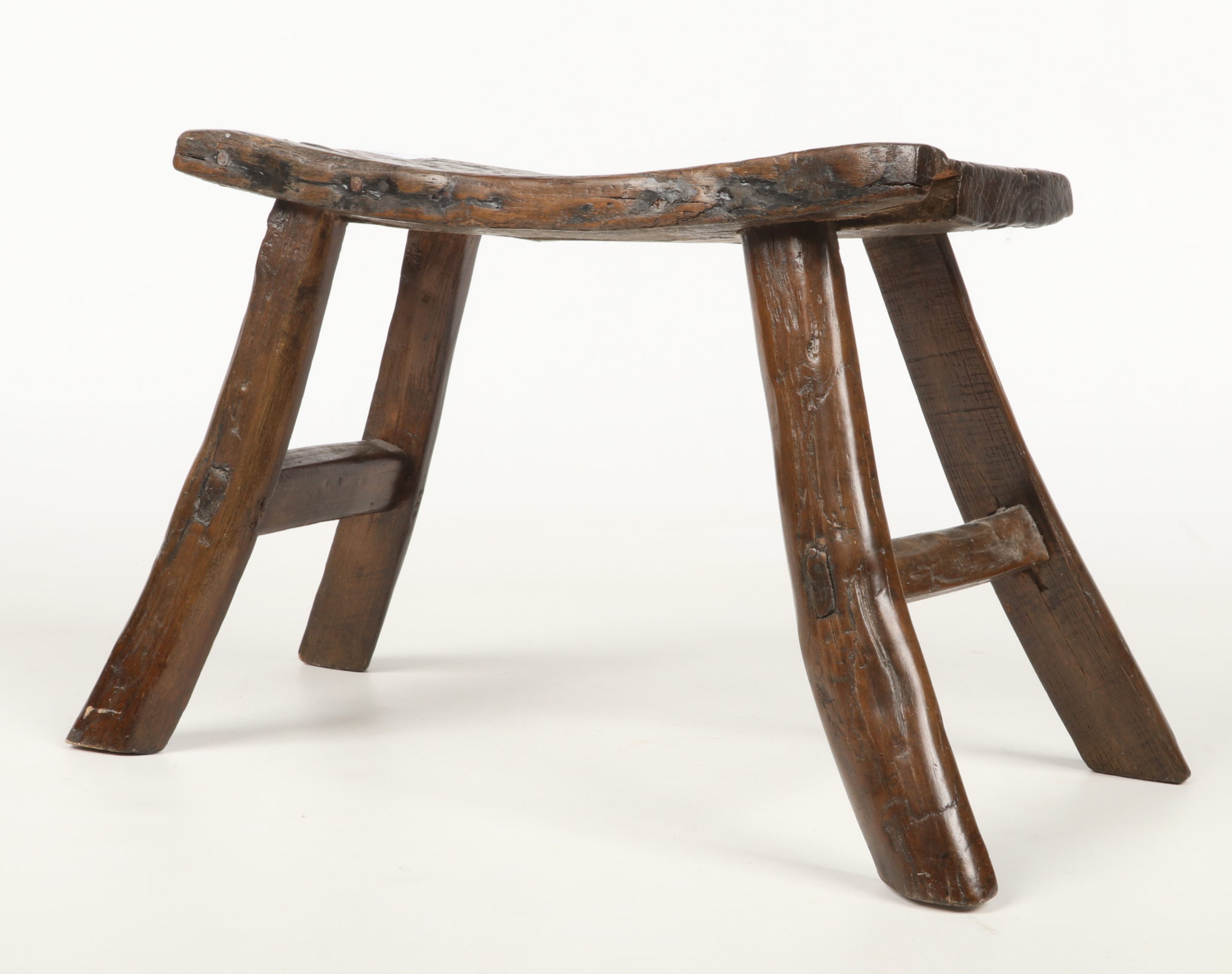 A period oak estate built small stool. With concave plank top, exposed tenons and splay supports,