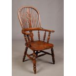 A Victorian ash and elm pad arm Windsor chair. With pierced splat and double turned cross stretcher.