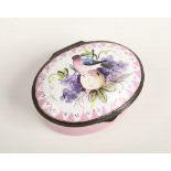 An 18th century oval enamel patch box with hinged cover. Pink ground and decorated to the cover with