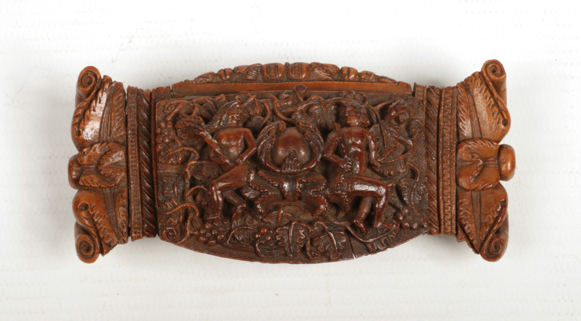 A 19th century carved coquilla nut snuff box with hinged cover. Decorated to the top with two