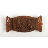 A 19th century carved coquilla nut snuff box with hinged cover. Decorated to the top with two