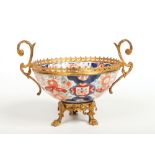 A Japanese late Meiji period Imari fluted bowl with ormolu mounts, having double scrolling handles