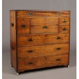 A 19th century camphor wood and brass bound campaign chest with a central drawer fitted with a