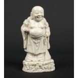 A Chinese blanc de chine figure of Liu Hai. Stood holding a peach in one separately modelled and