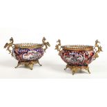 A near pair of Japanese late Meiji period fluted Imari ovoid planters with later French ormolu