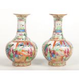 A pair of 19th century small Cantonese bottle vases. Ground with roses, fans and butterflies and